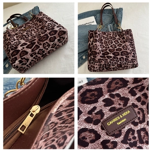 Detail view of large leopard print tote bag with leather strap and chain shoulder handle