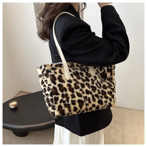 Close-up of leopard print faux fur tote bag showing plush texture and leather handles