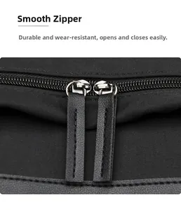 Detail of smooth metal zippers with leather pulls on durable black Oxford fabric