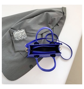 Klein blue PU leather tote bag detail with crocodile pattern and inner zipper pouch
