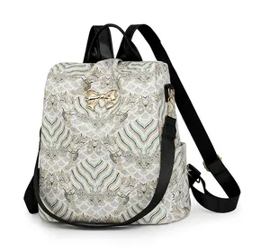 Detail of a vintage pattern backpack with a golden butterfly metal clasp and side view