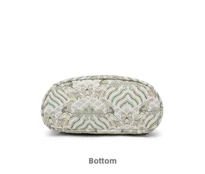 Detailed bottom view of vintage style backpack featuring traditional green wave brocade texture