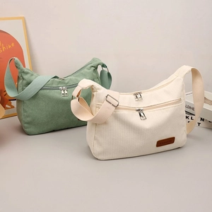 Minimalist corduroy crossbody bag with double zippers in mint green and off-white colors