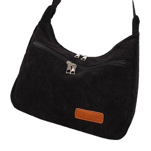 Classic black corduroy crescent shoulder bag with dual zippers and leather patch