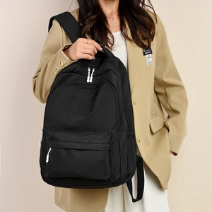 Large capacity black backpack with white contrast zippers for travel and school