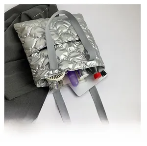 Quilted metallic silver tote bag showing large capacity for laptop and daily essentials