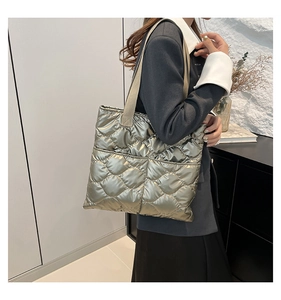 Detail of quilted metallic tote bag with champagne gold finish and khaki canvas straps
