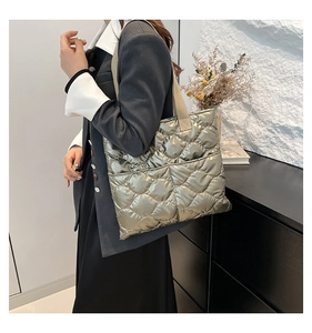 Quilted down metallic tote bag with large capacity shown on shoulder for daily commute
