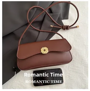 Brown leather crossbody bag size comparison with smartphone showing compact dimensions
