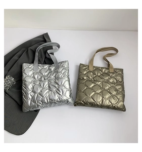 Close-up of quilted tote bags in silver and bronze metallic finish with diamond patterns