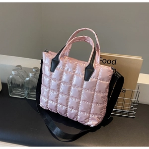 Detailed view of pink quilted padded tote bag with satin finish and black straps