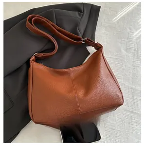 Brown litchi grain tote bag size comparison shown with a smartphone on textured background