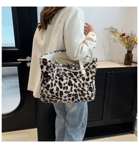 Detailed close-up of leopard print faux fur tote bag with white leather shoulder strap