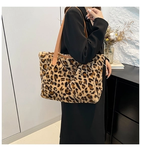 Detail view of plush leopard print tote bag with soft faux fur texture and leather strap