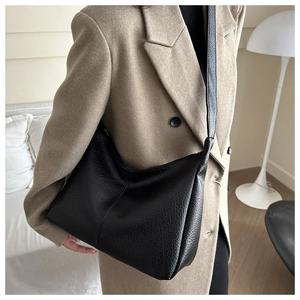 Detail of black lychee grain leather hobo bag with adjustable shoulder strap for women