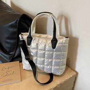 White pearl quilted tote bag with black straps and adjustable shoulder strap for women