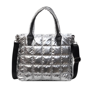 Metallic silver quilted tote bag with black handles and detachable shoulder strap