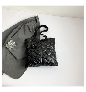 Detailed view of the black quilted puffer tote bag with premium diamond stitch pattern