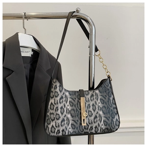 Close-up of leopard print hobo bag with a gold metal lock and chain strap detail