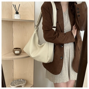 Detailed view of the soft beige faux leather texture on this large hobo shoulder bag
