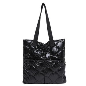 Quilted tote bag in black glossy fabric with diamond stitching and shoulder straps