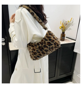 Detail view of leopard print plush underarm bag worn with white coat for autumn winter