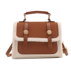 Vintage brown leather crossbody bag with beige faux shearling trim and metal buckles