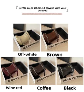 Five glossy leather underarm bags in various colors with metal chain shoulder straps