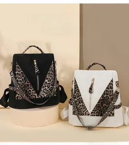 Detail view of leopard print patchwork and decorative zipper on the waterproof backpack