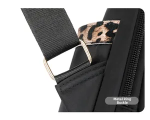 Detail of gold rectangular metal buckle and leopard print strap on black backpack