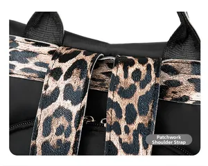 Detail of travel backpack with leopard print stitched shoulder strap and black fabric texture