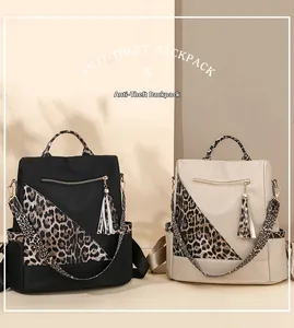 Detail of anti-theft backpacks in black and beige with stylish leopard print patchwork