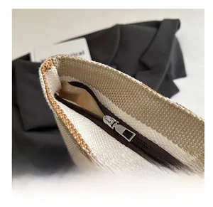 Detail view of the smooth silver zipper and striped woven texture on a tote bag
