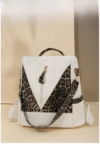Detail view of the leopard print contrast and premium gold zipper on the stylish backpack