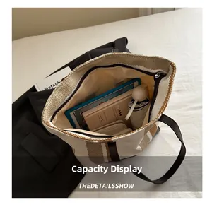 Top-down view of striped canvas tote bag showing large capacity with daily essentials