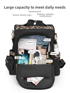 Interior view of black nylon backpack showing large capacity and leopard print trim detail