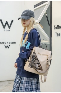 Detail of travel backpack with leopard print wide strap and elegant fringe zipper pull