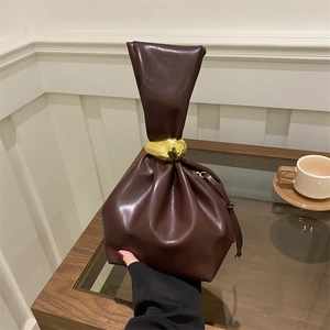 Retro pleated burgundy bucket bag with golden buckle and sleek tassel detail