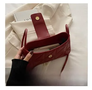 Interior view showing capacity of red quilted leather crescent shoulder bag for women