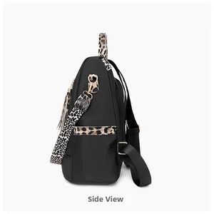 Detail of travel backpack with leopard print straps, gold hardware and side tassel zipper