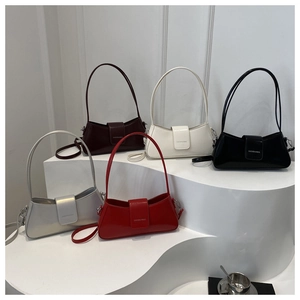Detailed display of underarm bags in five colors with silver logo on tiered white podium