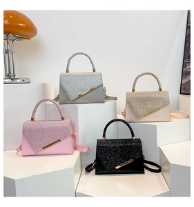 Detailed display of four PU leather handbags with glitter lids and gold metal accent