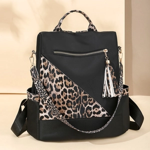 Fashionable leopard print and black nylon backpack with dual shoulder straps and long tassels