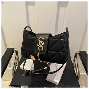 Detail of black quilted leather shoulder bag with gold SSS hardware and tassel accent
