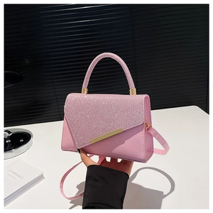 Elegant pink rhinestone flap handbag with a round handle and gold-tone metal hardware