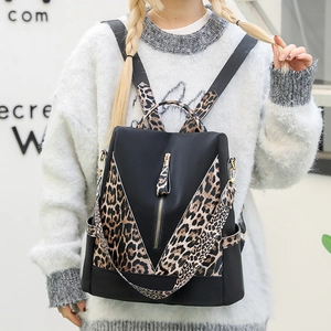 Waterproof black nylon backpack with leopard print trim and vertical zipper pocket