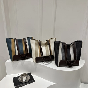 Three elegant striped canvas tote bags with leather trim displayed for daily commuting