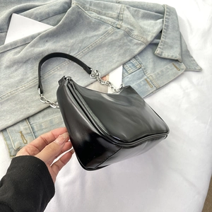 Detail view of black hobo shoulder bag with silver chain strap and smooth leather texture