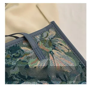 Gros plan sur les coutures précises et le tissu floral tissé d'un sac cabas vintage