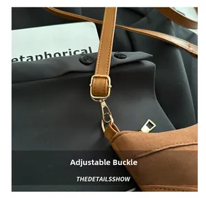 Detail of brown leather strap with adjustable golden metal buckle and lobster hook